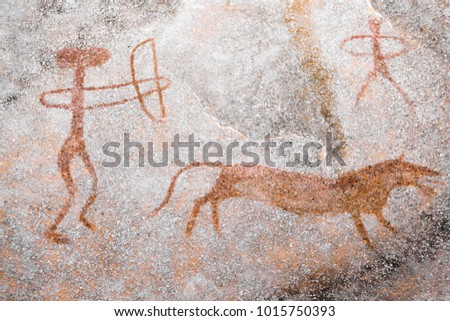 A scene of animal hunting performed ocher on the wall of the cave. Ancient people. stone Age. archeology
