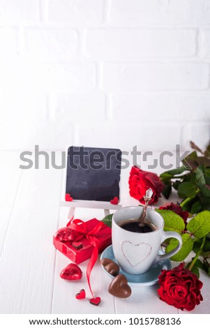Red rose, coffee cup and gift box