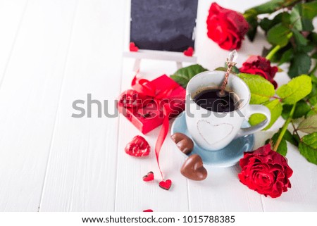 Red rose, coffee cup and gift box