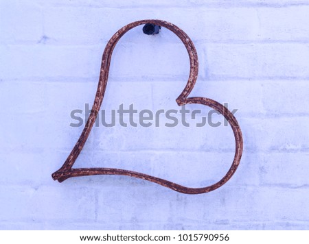 Decorative Heart Hanging on a White Brick Wall 