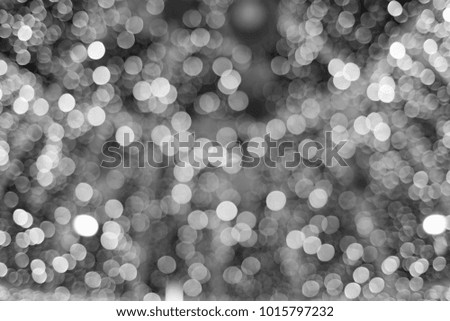 Celebratory background of white lights in blur - black and white