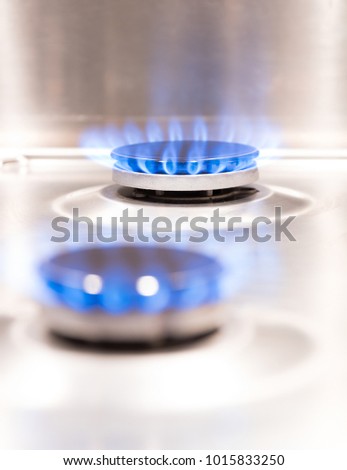 gas flames on a stove, co2 emission Royalty-Free Stock Photo #1015833250