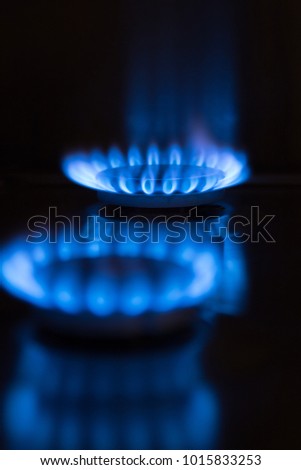 two blue gas flames, co2 emission Royalty-Free Stock Photo #1015833253