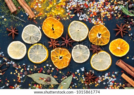 set of dried fruits and candied fruit for mulled wine with lemon, orange on a blue wooden background. Top view 
