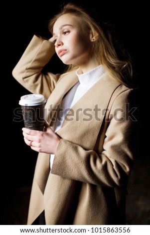 Beautiful young girl drinking coffee. Girl drinking an Americano in an old house. The girl in the old interior.
