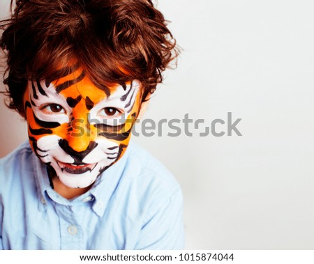 little cute boy with faceart on birthday party close up