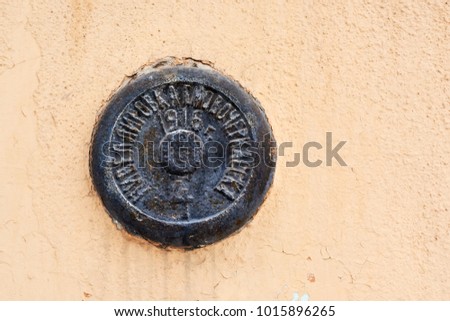Geodetic mark (sign) on the brick wall of the house in Novocherkassk, Russia