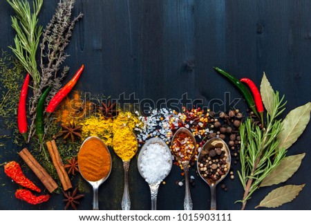 Spices in spoons on a blue wooden background. top view. with copy space