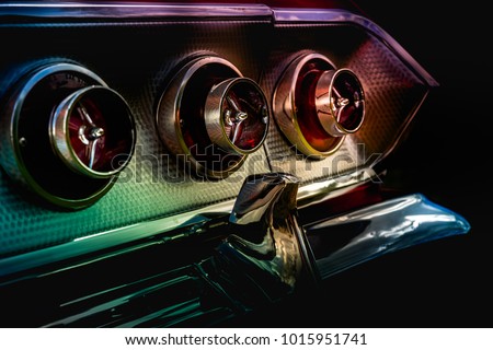 Detail of a vintage muscle car stop tail lights.  Royalty-Free Stock Photo #1015951741