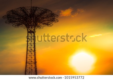 Silhouette of an amusement park structure at sunset. 