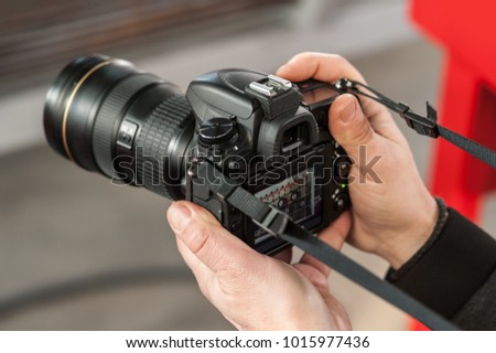 Man hand holding camera and take the photo. Selective focus