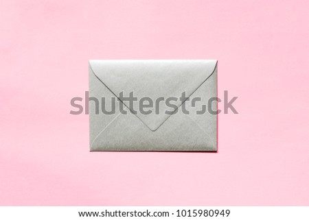 Silver envelope on pink background.