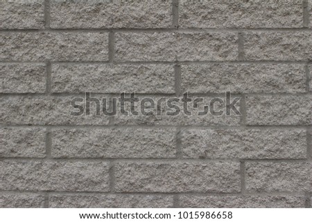 Textured light ash gray color brick wall background in traditional running bond pattern