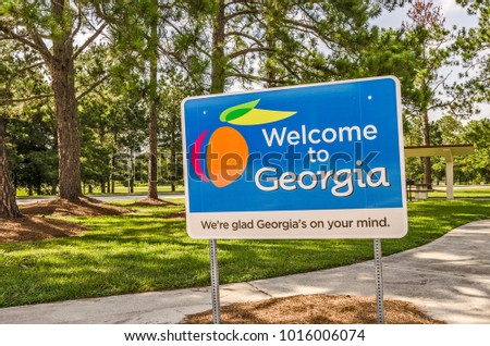 State sign for Georgia welcomes visitors in a shaded rest area