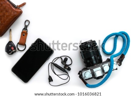 Camera and other travel accessories such as mobile phone , car key isolated on white background , top view with copy sapce Royalty-Free Stock Photo #1016036821