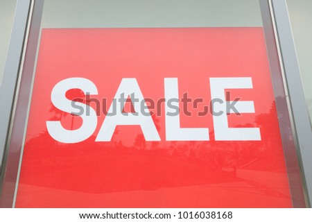 Red sign White Text Sale in Shop Display. Red Shopping billboard