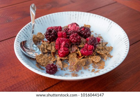 Healthy mixed red berry and cereal breakfast