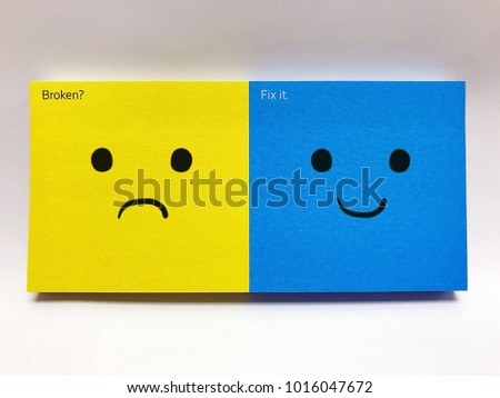 Sad and smile face on Yellow and blue note pad on white background