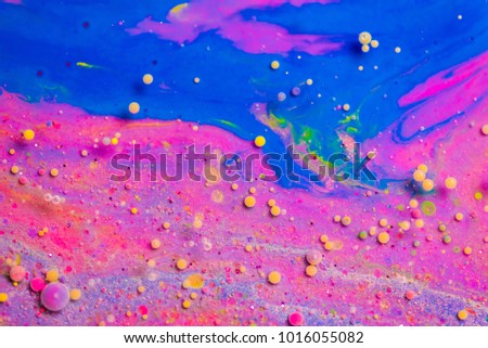 Colorful paint background in concept Fantasy luxury texture. Colors dropped into liquid and photographed while in motion. colorful circle abstract composition.