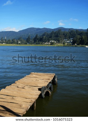Small Dock and Boat at the lake. Wooden jetty on a sunny day in nuwara eliya, sri lanka