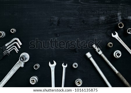 Tools for work or repair auto on black wooden background. Top view. Still life. Copy space. Flat lay