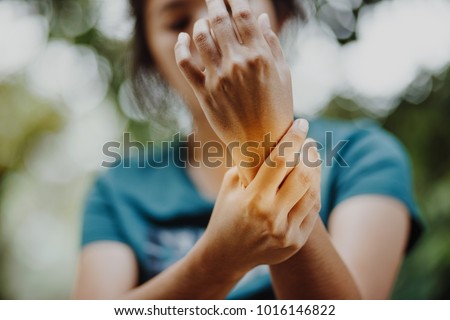 Close up young woman Left wrist pain , office syndrome , health care concept, Guillain Barre Syndrome Royalty-Free Stock Photo #1016146822