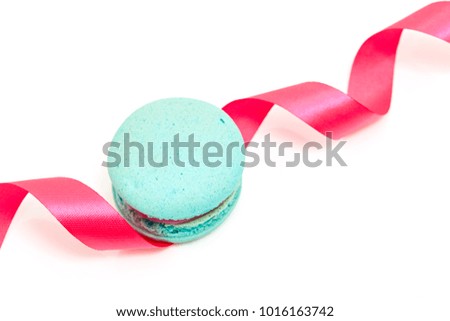 Valentine's blue macaron with pink ribbon on white background, minimal concept holiday