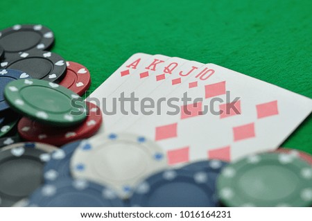 A royal flush displayed with poker chips. Shallow depth of field