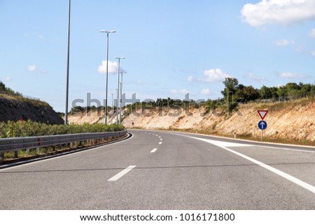 Scenic view on highway road leading through in Istria, Croatia, Europe / Beautiful natural environment, sky and clouds in background / Transport and traffic infrastructure / Road signs and signaling.