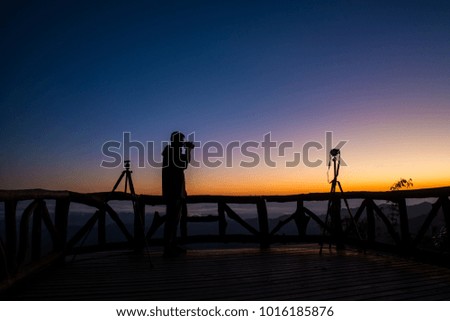The man take a photo on mountain viewpoint