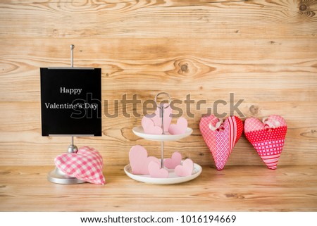 Pink hearts for valentines day  in front of a wood background