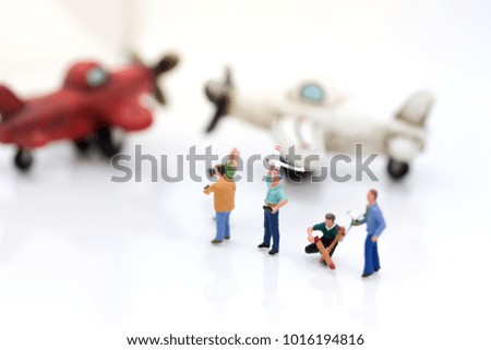 Miniature people: Group people playing and operating plane with remote control . Image use for background technology, business concept.