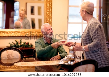 Senior woman bring service of tea to her husband, love this is for you