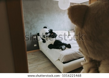 Men with animal costumes spending time inside the house