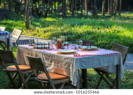Wood chair and table in the restaurant on nature background.
