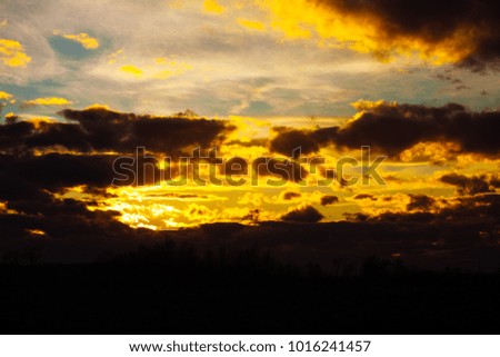 Large bright orange clouds on a blue sky during sunset. Beautiful sky on twilight time.