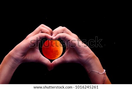 Love sign concept : hand heart shape with full moon