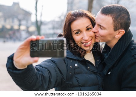 Happy couple taking a selfie outdoors