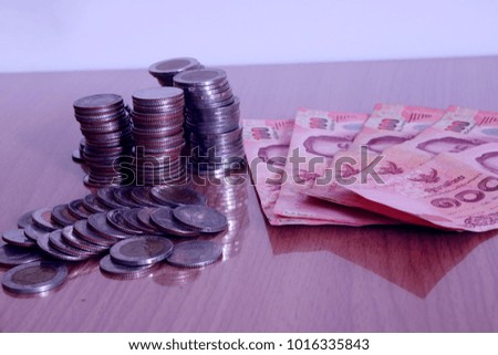 
Alarm clock and step of coins stacks on working table, time for savings money concept, banking and business idea. vintage tone.