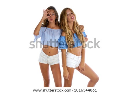 Teen best friends girls happy together looking through finger goggles