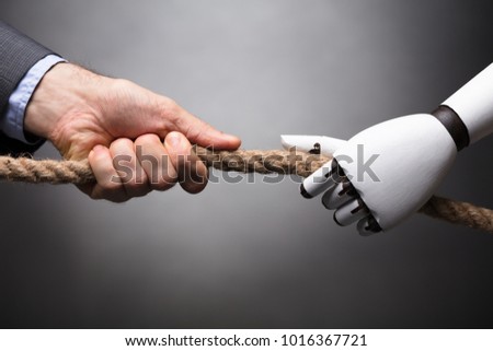 Businessperson And Robot Playing Tug Of War On Gray Background