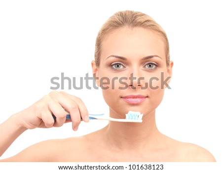 Attractive young woman with a toothbrush on white background close-up