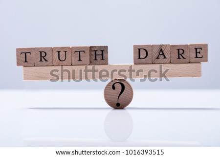 Truth And Dare Arranged Blocks Are Balanced On The Wooden Seesaw With Question Mark Royalty-Free Stock Photo #1016393515