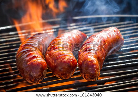 BBQ with fiery sausages on the grill Royalty-Free Stock Photo #101643040
