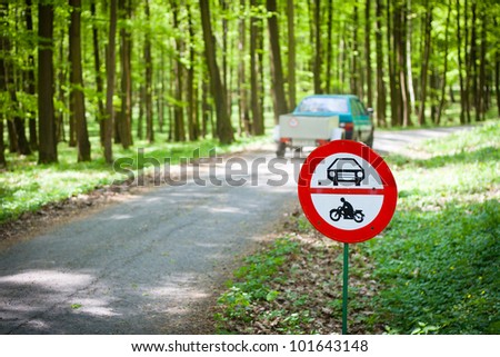 Breaking traffic rules concept: no motor vehicles sign at the edge of a  protected forestal landscape area
