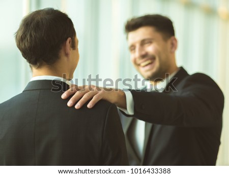 The happy businessmen pat on the shoulder in the office Royalty-Free Stock Photo #1016433388