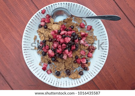 Mixed red berries and bran flakes breakfast