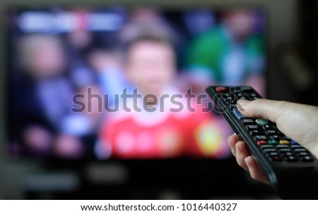 Binge watching TV shows and football Royalty-Free Stock Photo #1016440327
