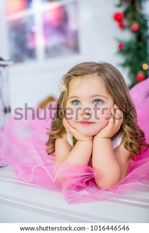 Creative portrait of a little princess child in a pink dress, closeup