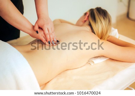 Body care. Spa body massage treatment. Woman having massage in the spa salon Royalty-Free Stock Photo #1016470024